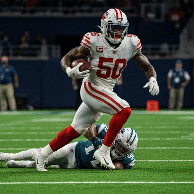 Najee Harris as a running back breaking through a tackle on the field