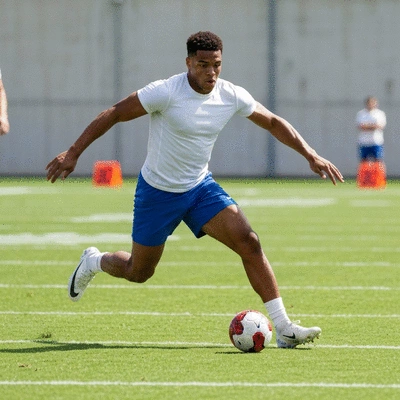 Football player in action, illustrating skill evolution